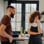 Young couple arguing in kitchen after having a fight
