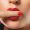 Beauty and cosmetics. Female mouth and nails with red manicure and lipstick.